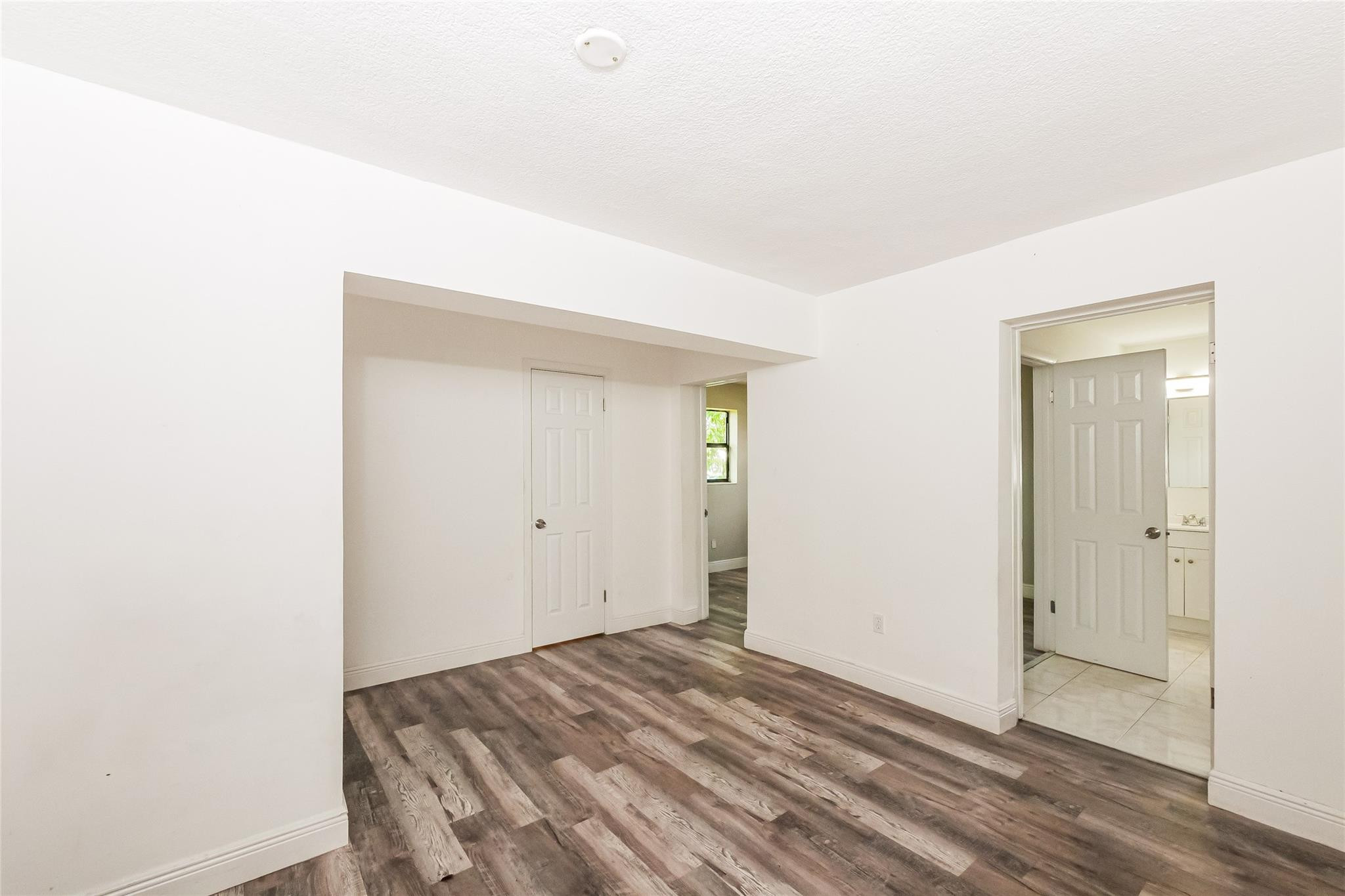 730 Northwest 18th Street Pompano Beach, FL 33060 - Photo 8 of 15 a view of a room with wooden floor and closet