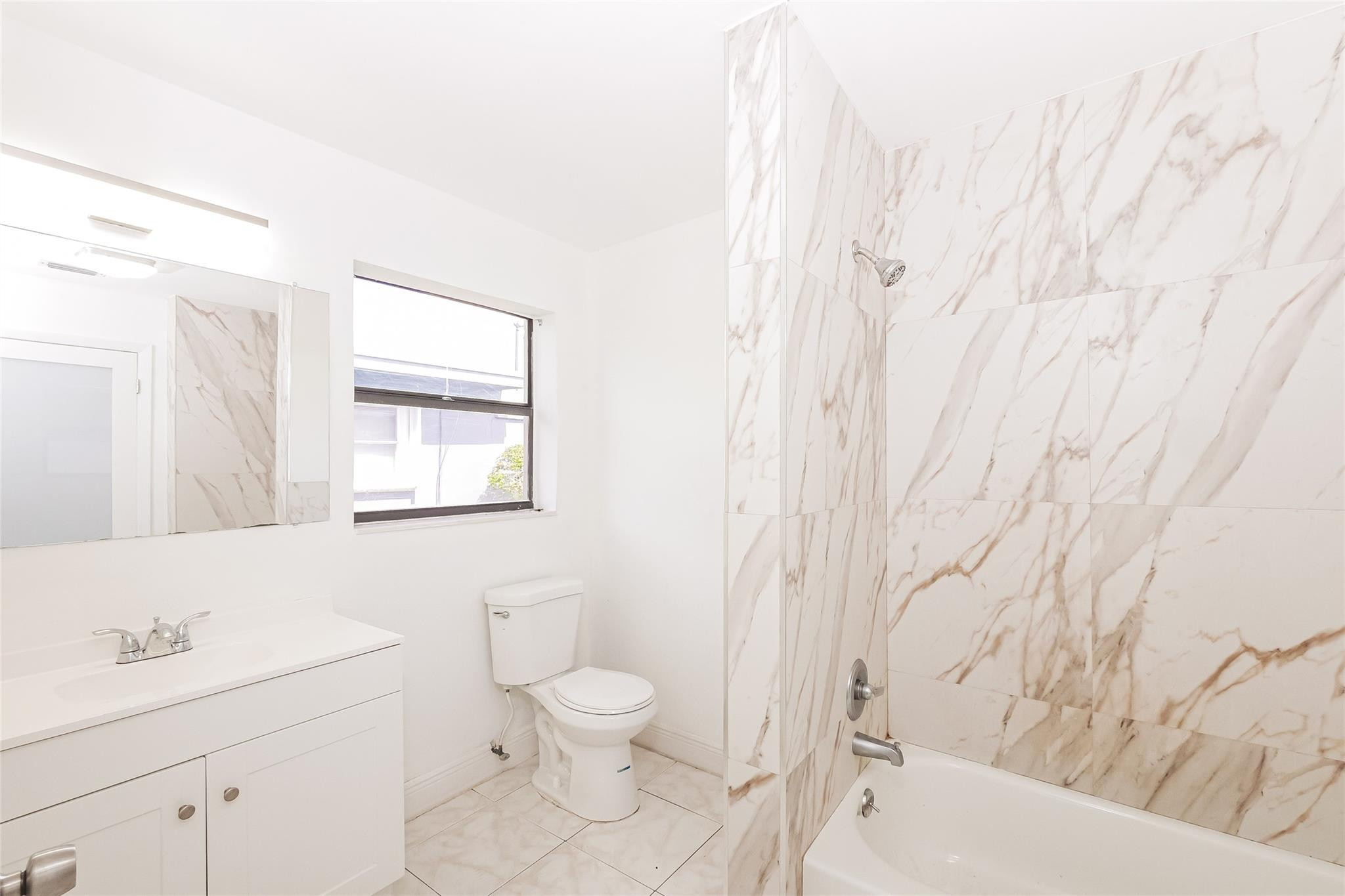 730 Northwest 18th Street Pompano Beach, FL 33060 - Photo 10 of 15 a bathroom with a sink toilet and shower