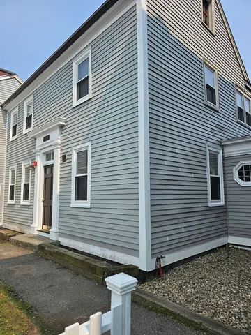a view of a house with a yard and a garage