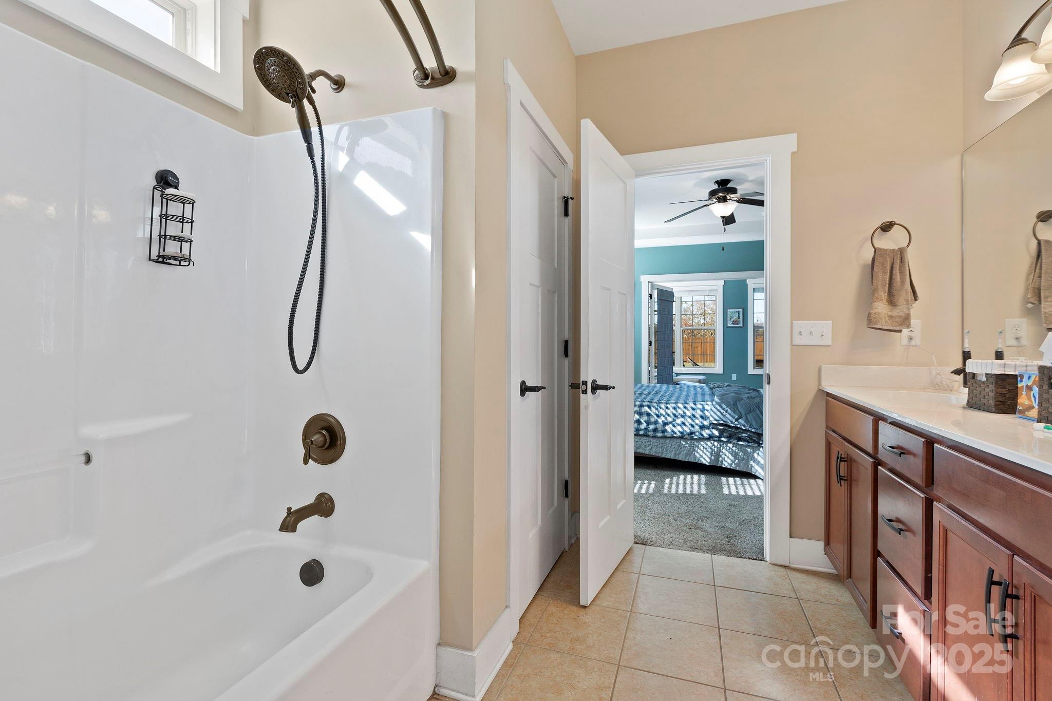 28 South River Road Fletcher, NC 28732 - Photo 23 of 47 a bathroom with a tub a sink and a mirror