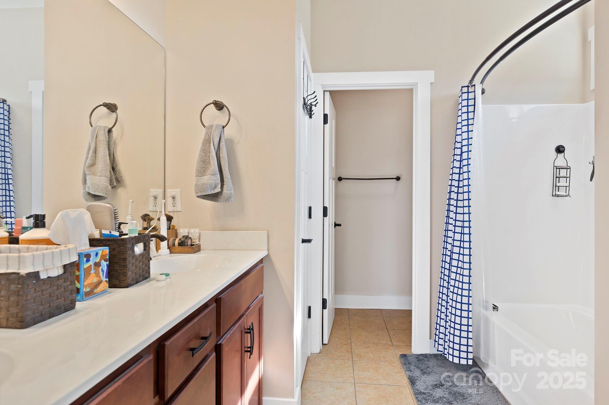 28 South River Road Fletcher, NC 28732 - Photo 24 of 47 a bathroom with a double vanity sink a mirror and a shower