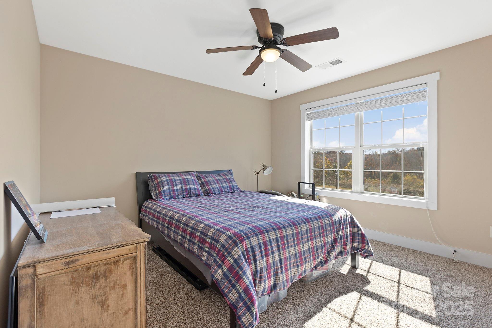 28 South River Road Fletcher, NC 28732 - Photo 29 of 47 a bedroom with a bed and a window
