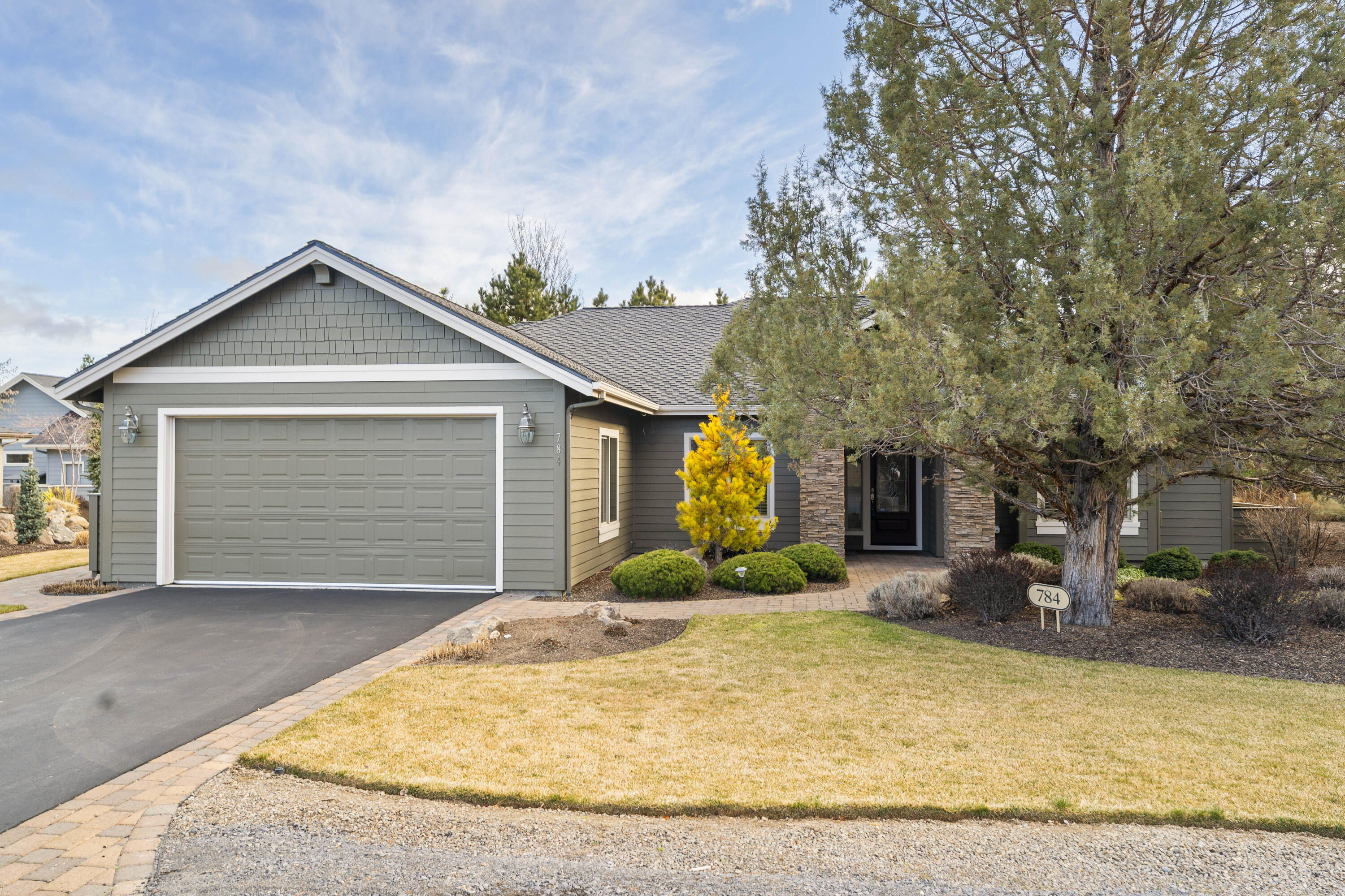784 Ribbon Falls Road Redmond, OR 97756 - Photo 2 of 79 a front view of a house with a yard and garage