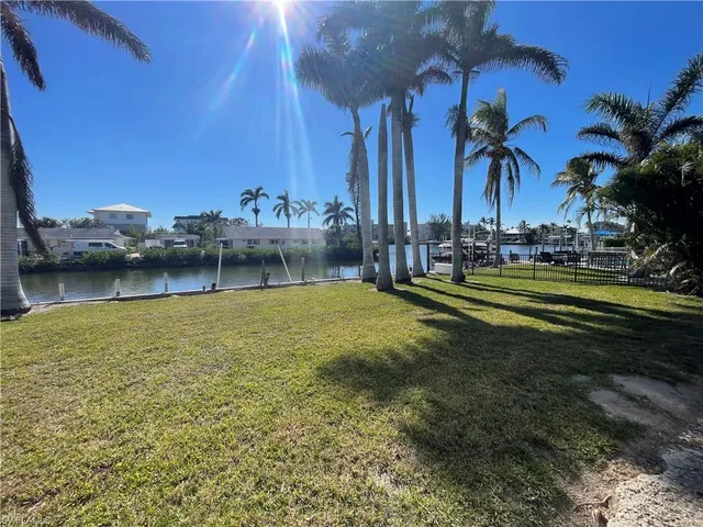 a view of a swimming pool and lounge chairs