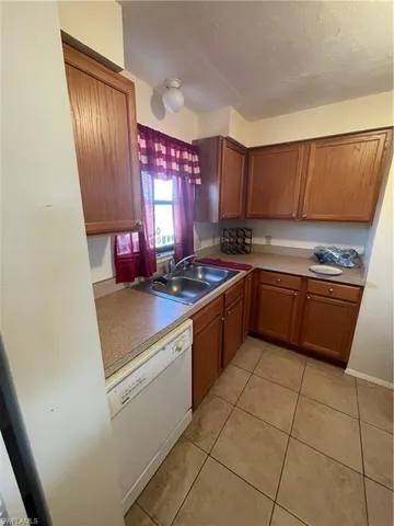 a kitchen with a stove sink and cabinets