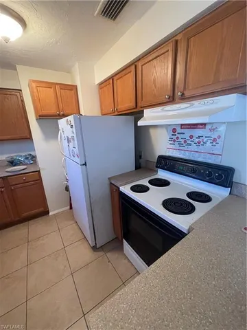 a kitchen with a stove and a refrigerator