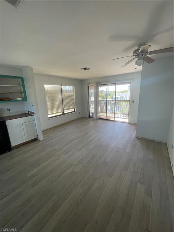 4861 Regal Drive Bonita Springs, FL 34134 - Photo 19 of 33 a view of an empty room with a window and wooden floor