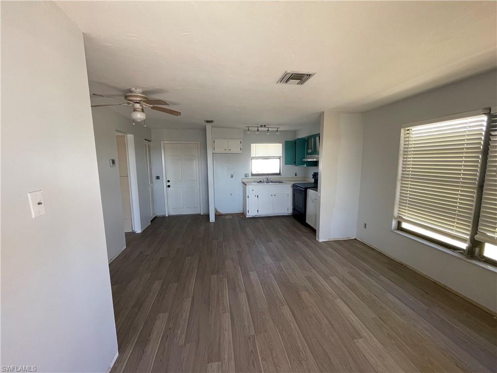 4861 Regal Drive Bonita Springs, FL 34134 - Photo 20 of 33 wooden floor in an empty room with a kitchen