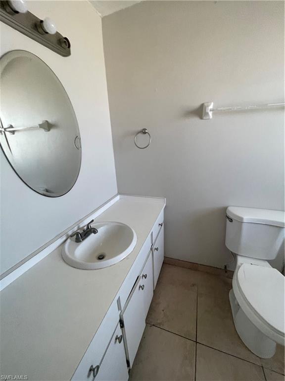 4861 Regal Drive Bonita Springs, FL 34134 - Photo 24 of 33 a bathroom with a granite countertop toilet sink and mirror