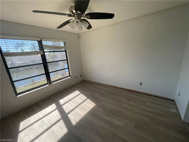 a view of a livingroom with a ceiling fan and window