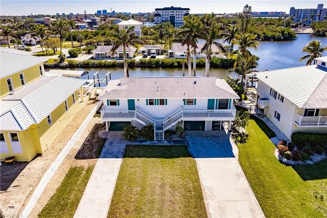 a view of a swimming pool with outdoor seating and a garden