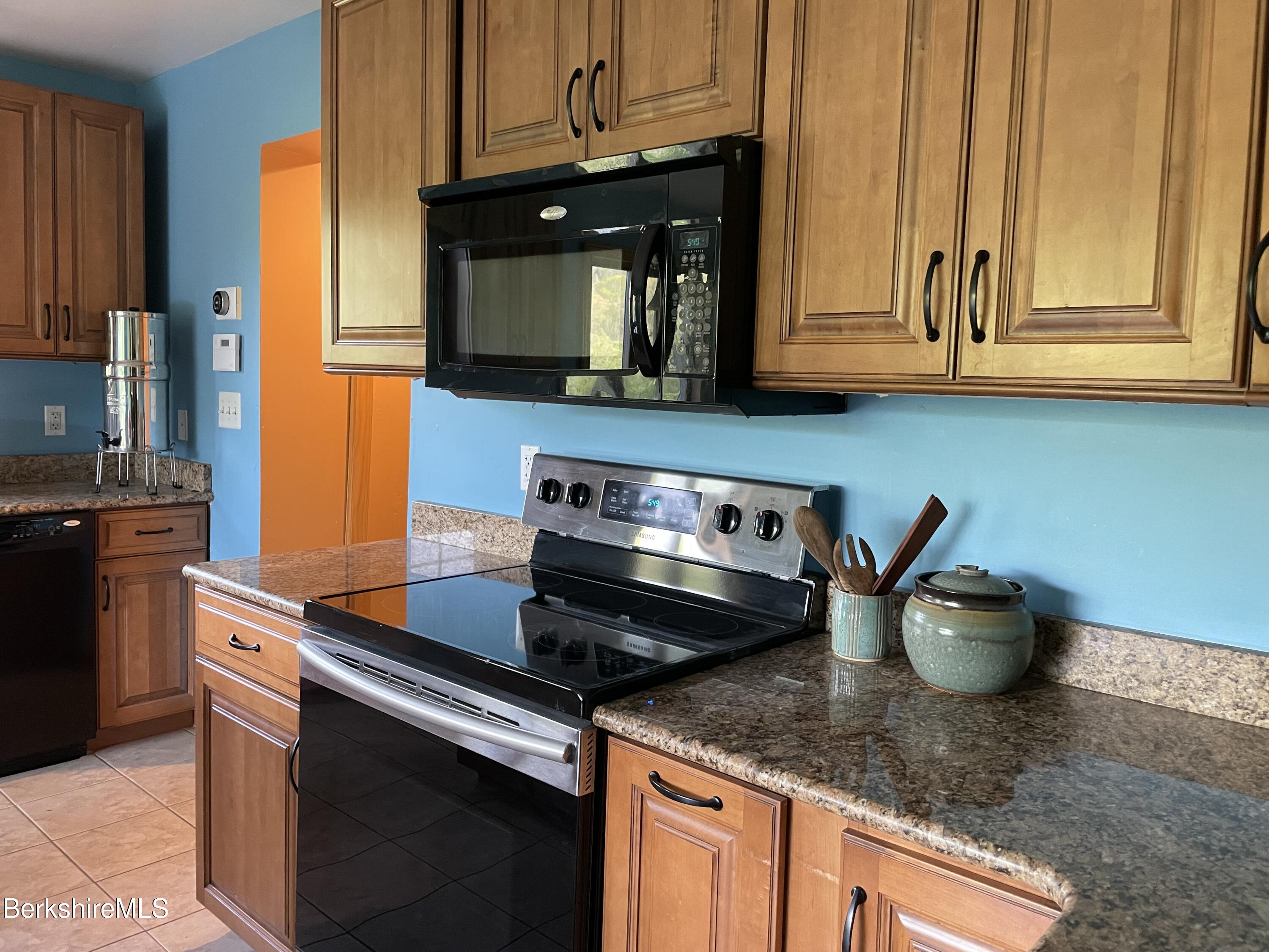 104 North Chester Road Chester, MA 01011 - Photo 14 of 54 a kitchen with stainless steel appliances granite countertop a sink a stove and microwave