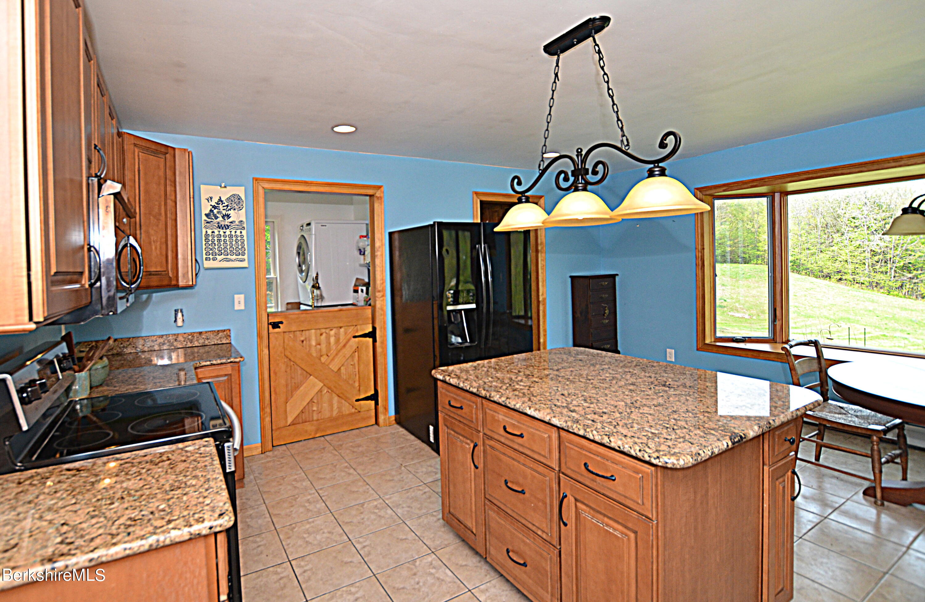 104 North Chester Road Chester, MA 01011 - Photo 15 of 54 a kitchen that has a kitchen island wooden cabinets and stainless steel appliances