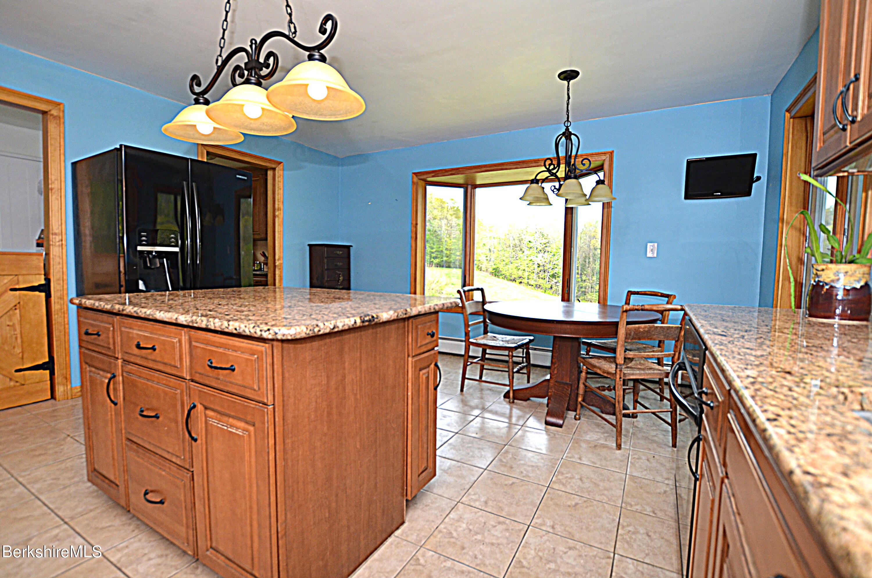 104 North Chester Road Chester, MA 01011 - Photo 17 of 54 a kitchen with stainless steel appliances granite countertop sink stove top oven and cabinets