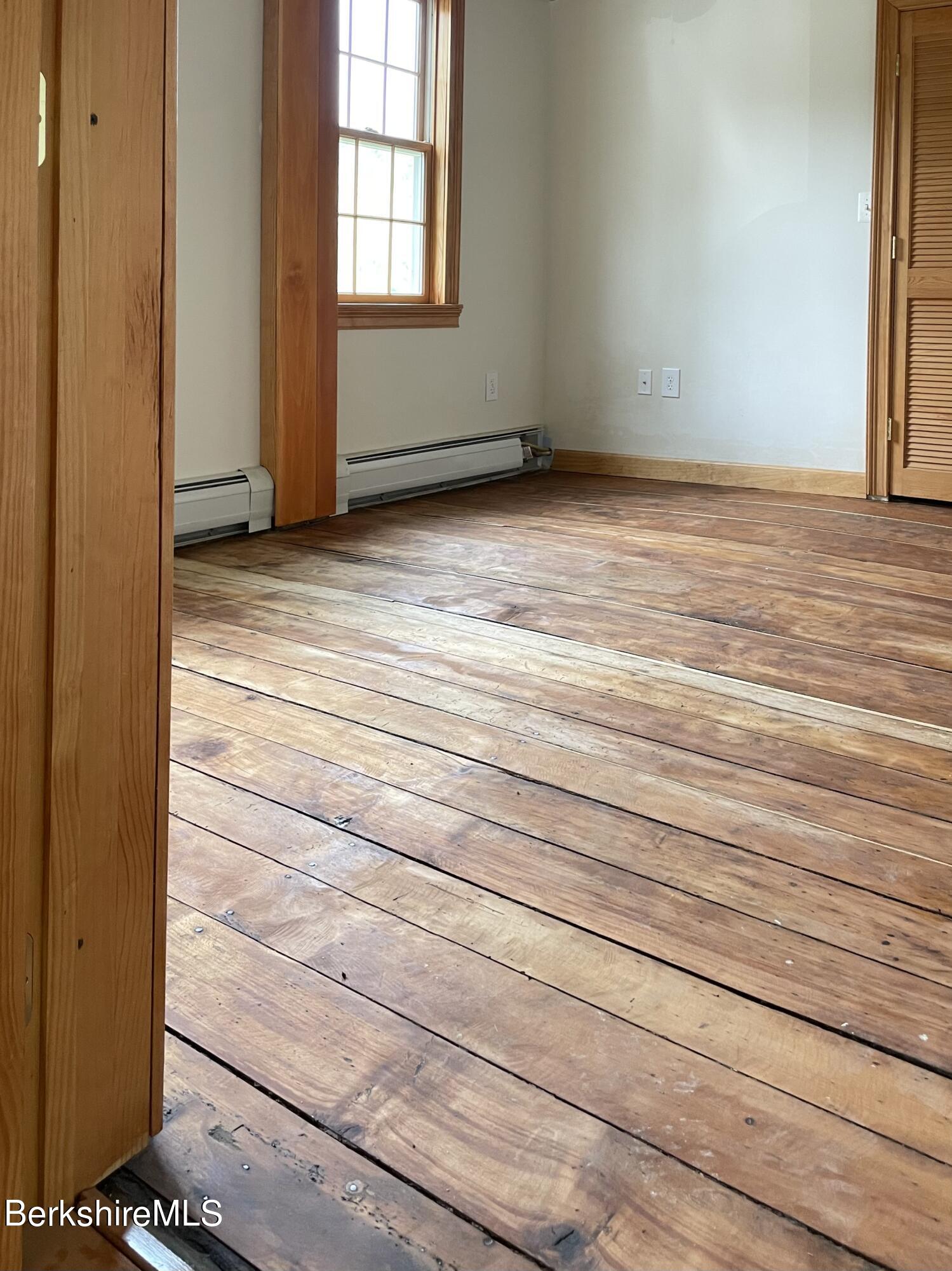 104 North Chester Road Chester, MA 01011 - Photo 21 of 54 a view of an empty room with wooden floor and a window