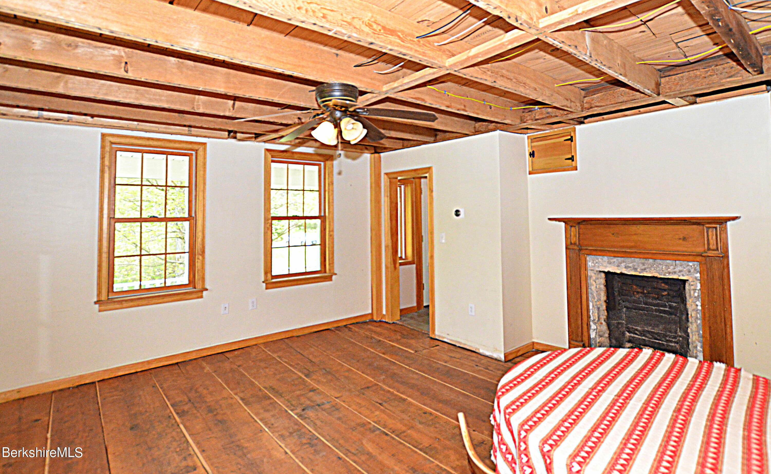 104 North Chester Road Chester, MA 01011 - Photo 27 of 54 a view of a livingroom with a fireplace and windows