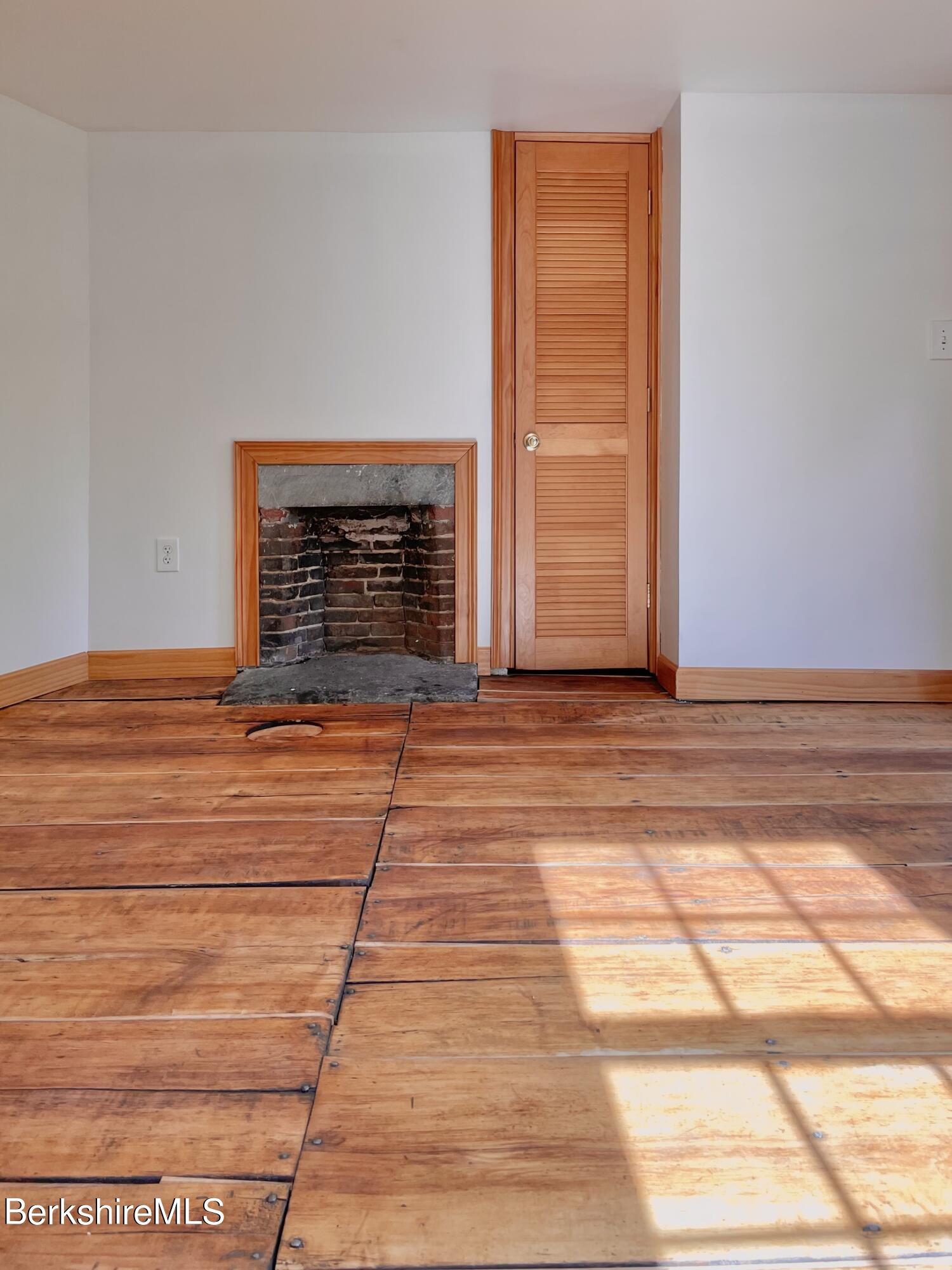 104 North Chester Road Chester, MA 01011 - Photo 31 of 54 a view of empty room with wooden floor and fan