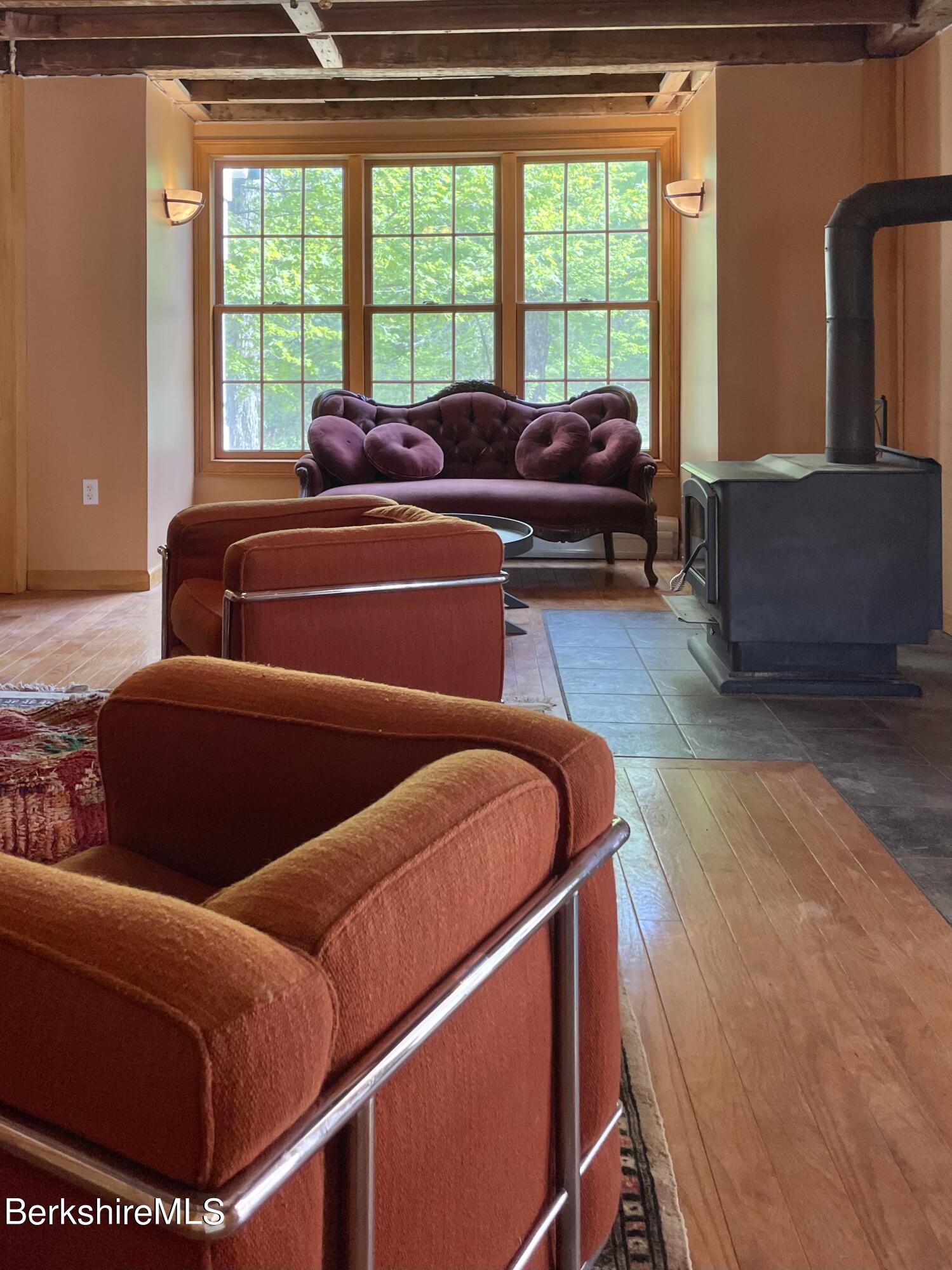 104 North Chester Road Chester, MA 01011 - Photo 10 of 54 a living room with furniture and a floor to ceiling window