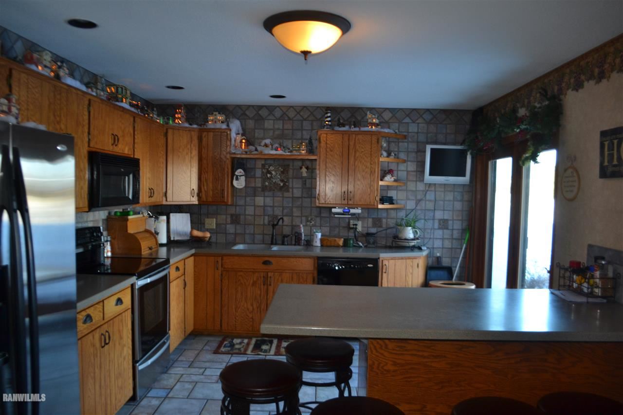 3018 South Golf Road Stockton, IL 61085 - Photo 5 of 24 a kitchen with stainless steel appliances granite countertop a sink a stove counter space and cabinets