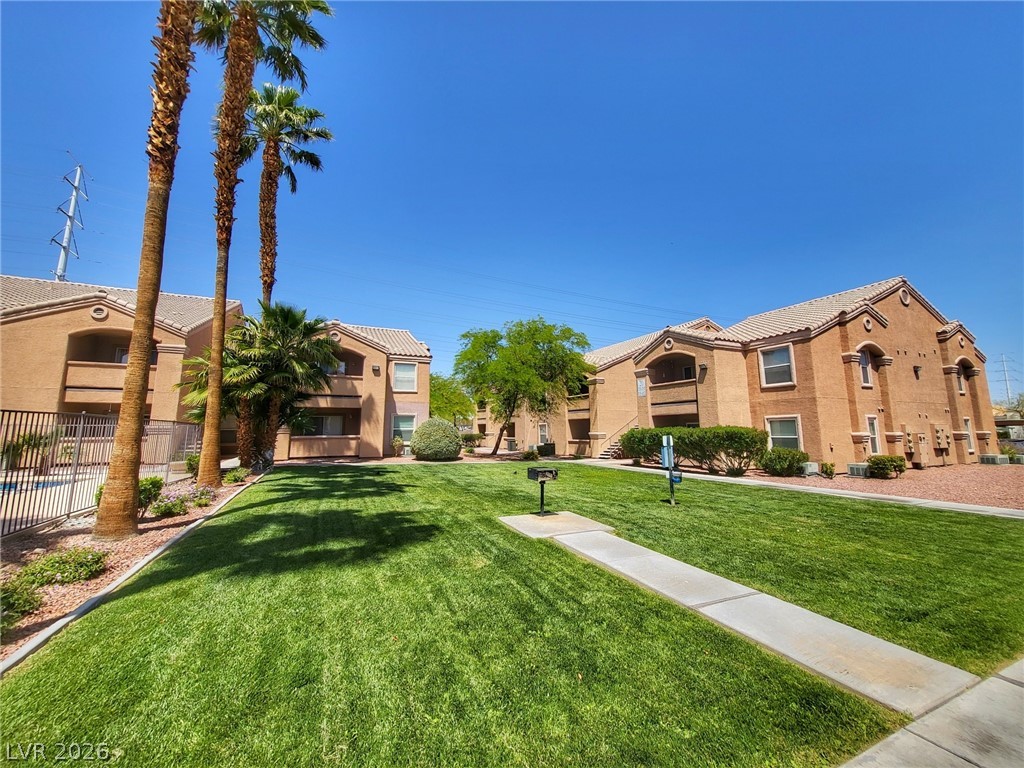 8101 West Flamingo Road, Unit 1160 Las Vegas, NV 89147 - Photo 14 of 18 This residential building features a well-maintained lawn and clear pathways.