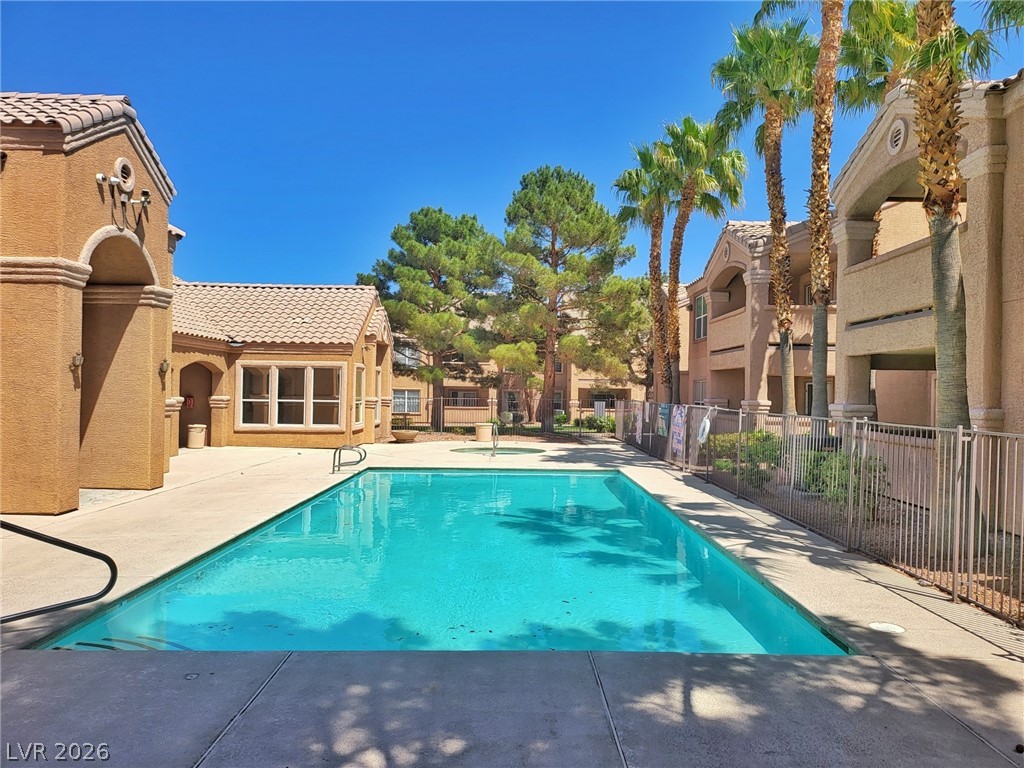 8101 West Flamingo Road, Unit 1160 Las Vegas, NV 89147 - Photo 15 of 18 Relax poolside in this inviting community oasis, surrounded by lush landscaping and architectural charm.