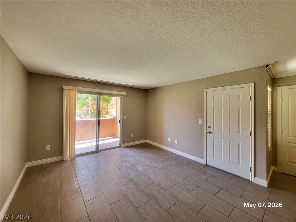 8101 West Flamingo Road, Unit 1160 Las Vegas, NV 89147 - Photo 3 of 18 This bright living space features durable tile flooring and access to a private balcony.
