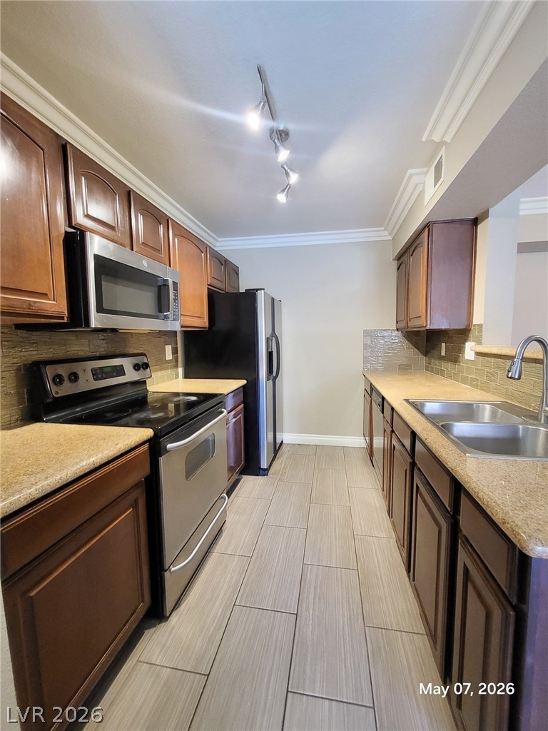 8101 West Flamingo Road, Unit 1160 Las Vegas, NV 89147 - Photo 6 of 18 This galley kitchen features durable countertops and sleek appliances, perfect for everyday living.