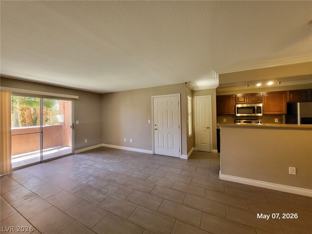 8101 West Flamingo Road, Unit 1160 Las Vegas, NV 89147 - Photo 7 of 18 This inviting space features a seamless flow from the living area to the kitchen and an outdoor patio.
