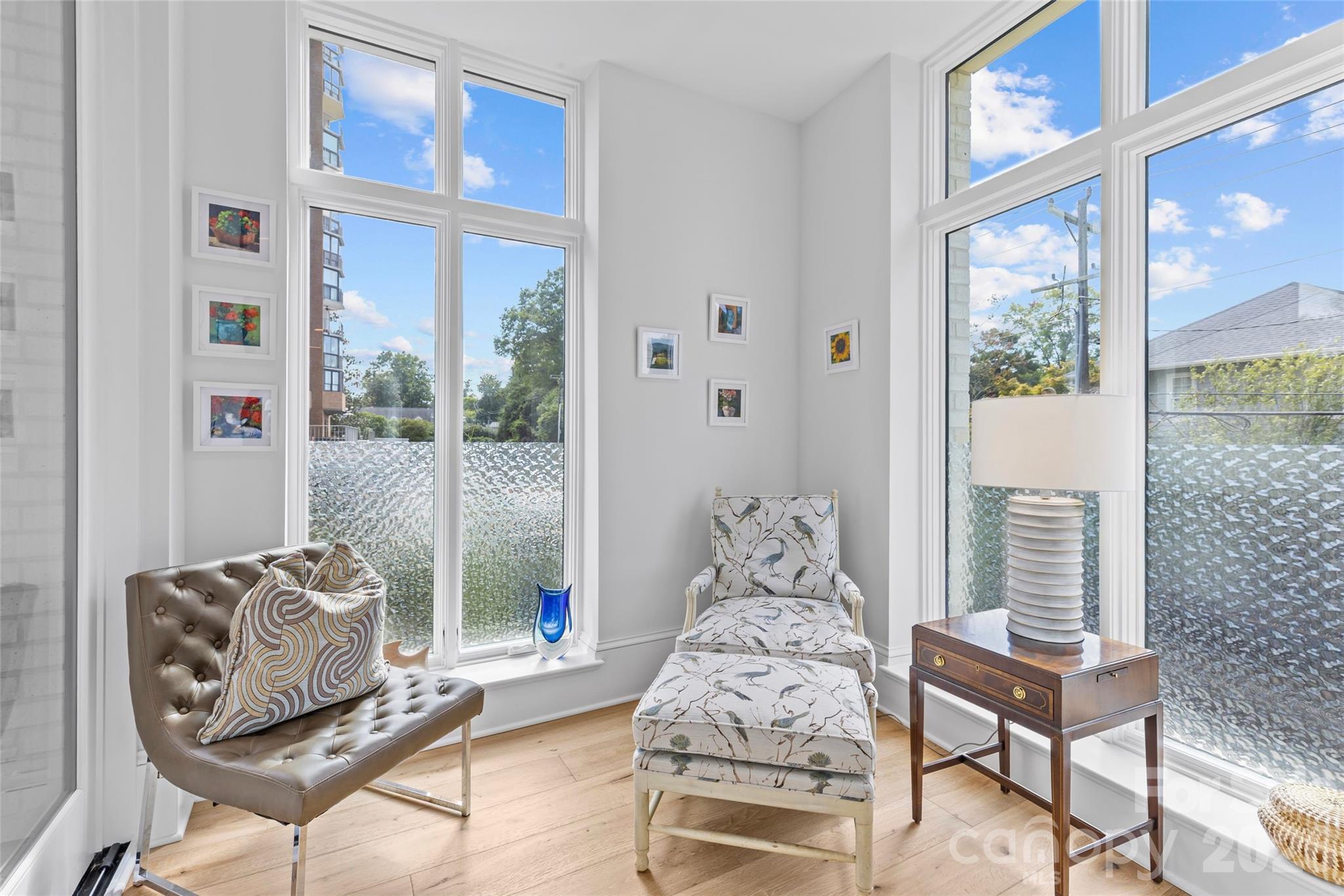 1500 Queens Road, Unit 104 Charlotte, NC 28207 - Photo 11 of 41 a living room with furniture and a floor to ceiling window