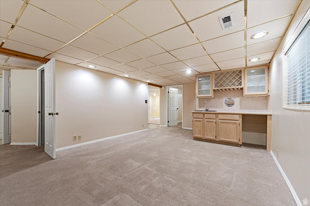 888 East 6895 South Midvale, UT 84047 - Photo 32 of 54 Expansive basement with built-in cabinetry, sink, and bar area, perfect for entertaining or multi-functional use.