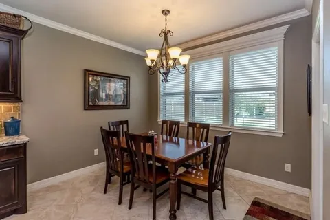 a view of a dining room with furniture and chandelier
