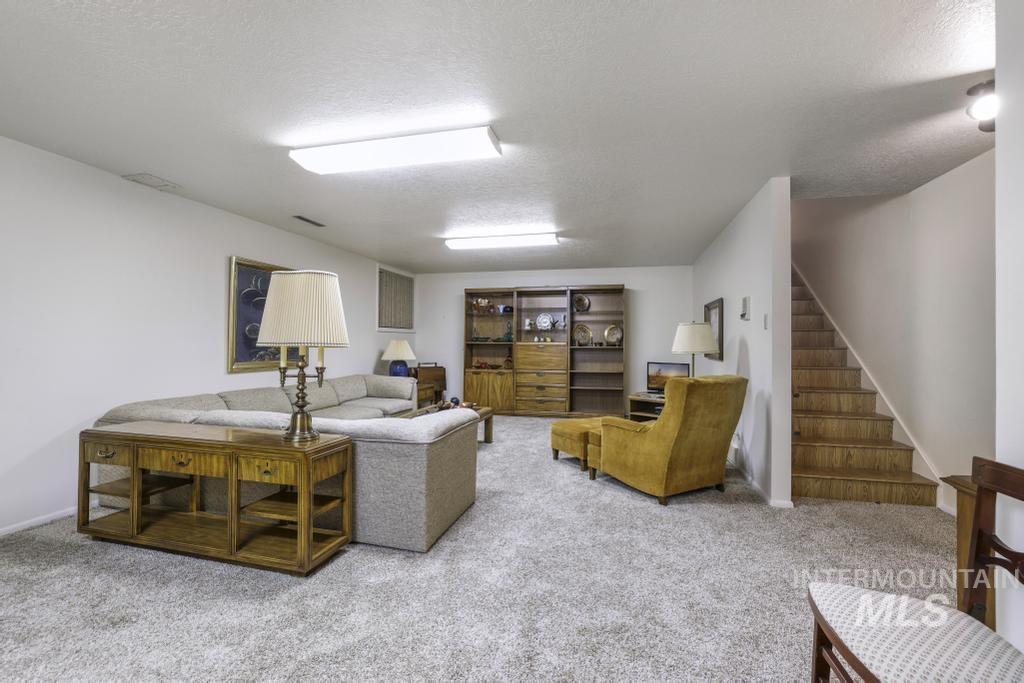 2018 Rancho Vista Drive Twin Falls, ID 83301 - Photo 38 of 50 Carpeted room with white walls, featuring recessed lighting fixtures and a built-in wooden bookcase with glass doors