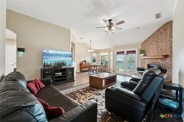 a living room with furniture a fireplace and a flat screen tv