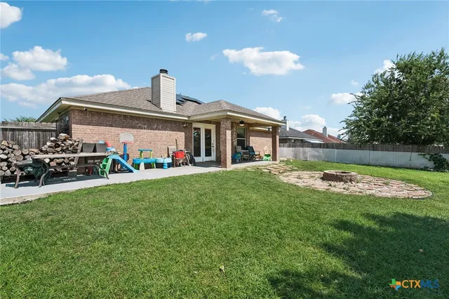 a front view of a house with a yard table and chairs