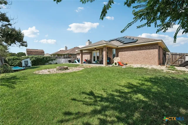 a view of a house with swimming pool and a yard