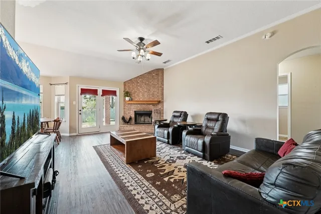 a living room with furniture a fireplace and a flat screen tv