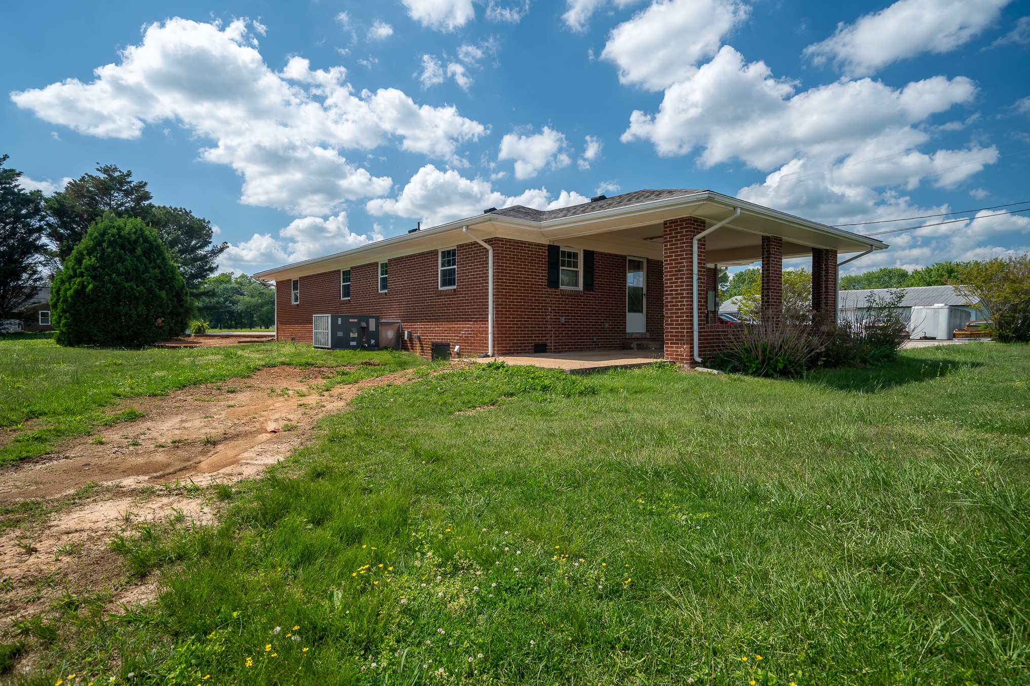 116 Smith Circle Loretto, TN 38469 - Photo 20 of 23 a view of a yard in front of a house with plants and large trees