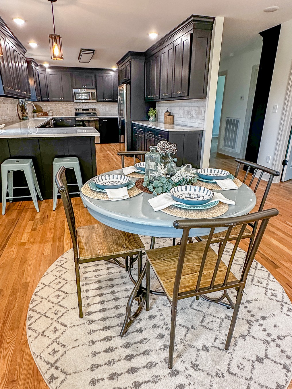 116 Smith Circle Loretto, TN 38469 - Photo 7 of 23 a kitchen with stainless steel appliances kitchen island granite countertop a stove a sink and a dining table