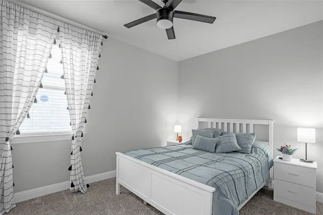 a living room with furniture fireplace and a large window
