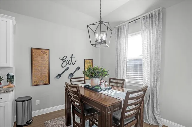 a view of a patio with table and chairs and potted plants