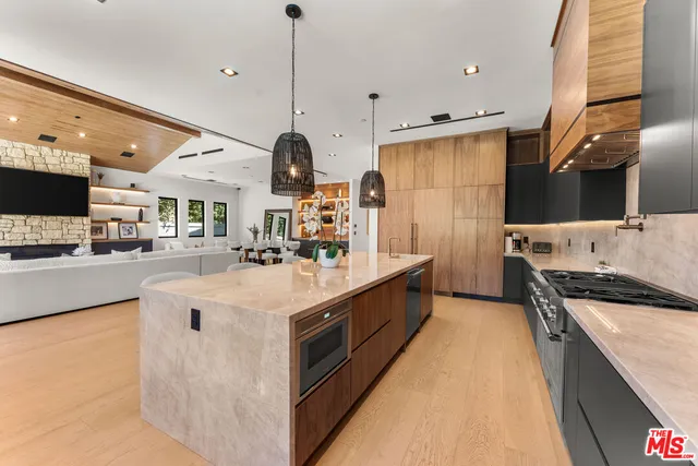 a kitchen with stainless steel appliances granite countertop a sink and a stove