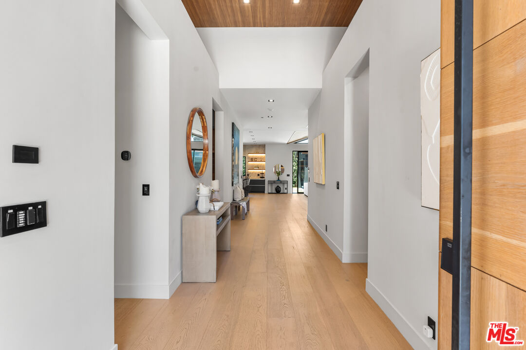 13463 Chandler Boulevard Sherman Oaks, CA 91401 - Photo 2 of 38 a view of a hallway with wooden floor and furniture