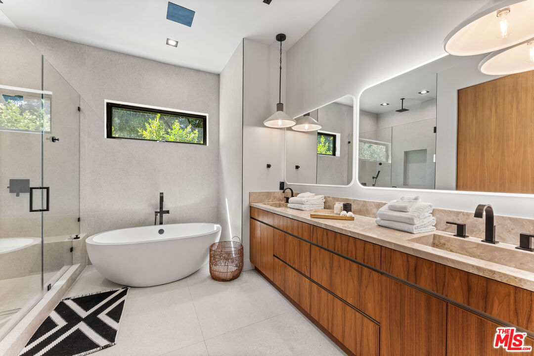 13463 Chandler Boulevard Sherman Oaks, CA 91401 - Photo 26 of 38 a spacious bathroom with a double vanity sink mirror and bathtub