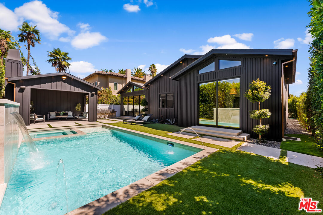 13463 Chandler Boulevard Sherman Oaks, CA 91401 - Photo 33 of 38 a view of a house with swimming pool and sitting area