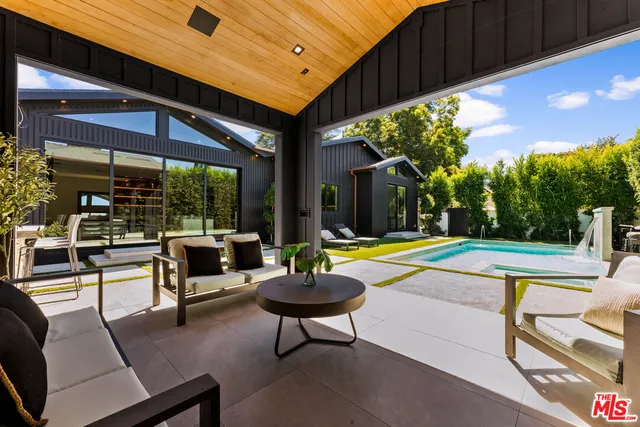 a swimming pool with outdoor seating and yard