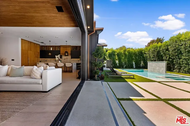 a view of a patio with swimming pool table and chairs