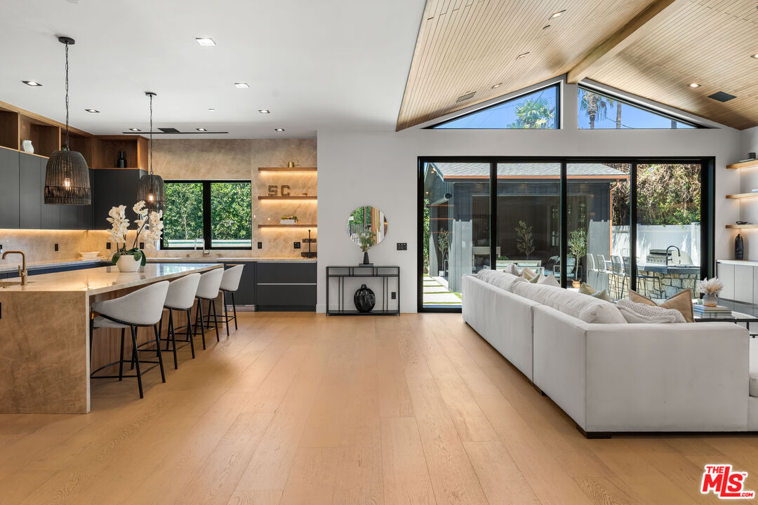 13463 Chandler Boulevard Sherman Oaks, CA 91401 - Photo 4 of 38 a living room with furniture a large window with kitchen view