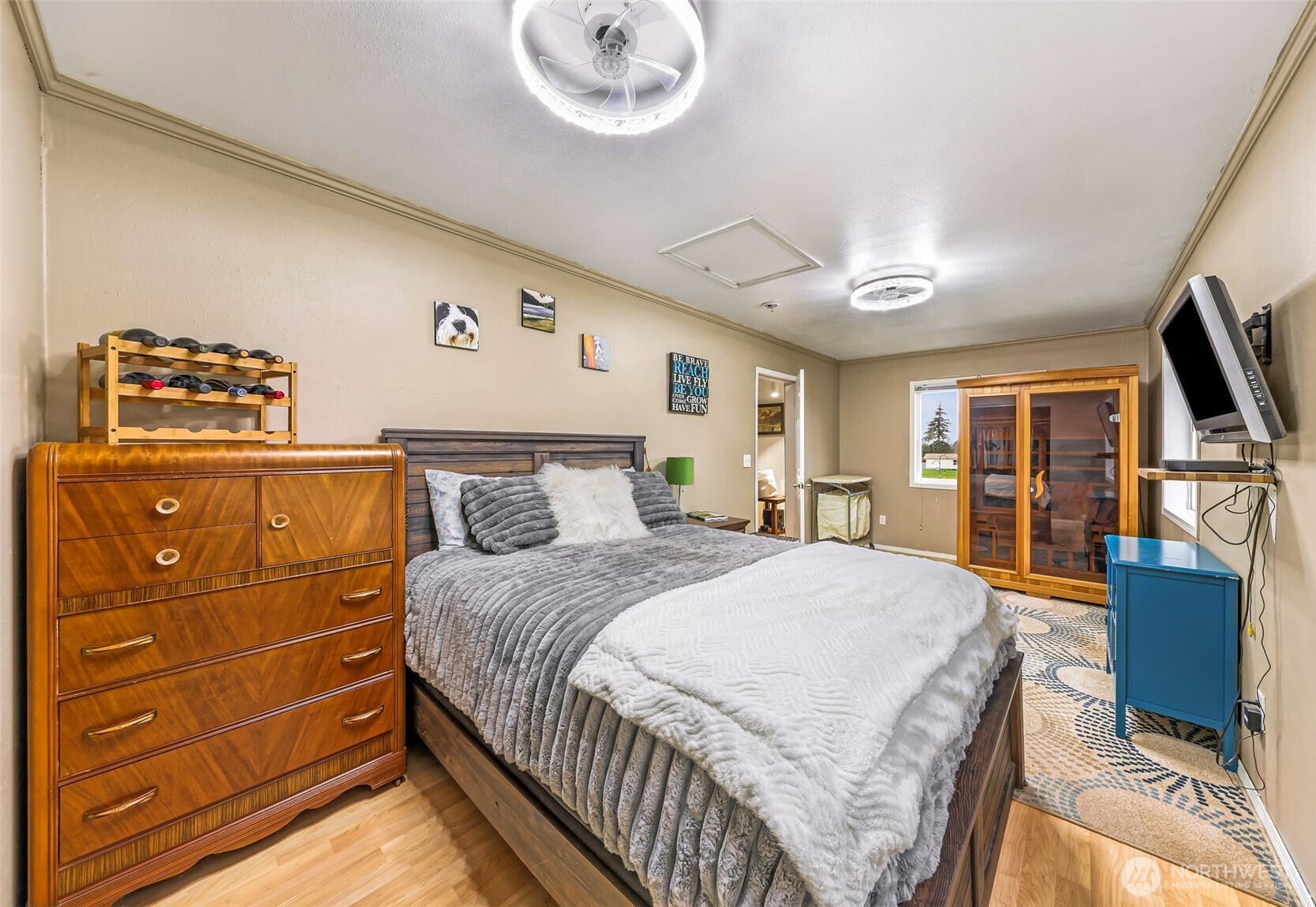 4610 Curtis Road Bellingham, WA 98226 - Photo 11 of 34 a bedroom with a large bed and a flat tv screen on dresser