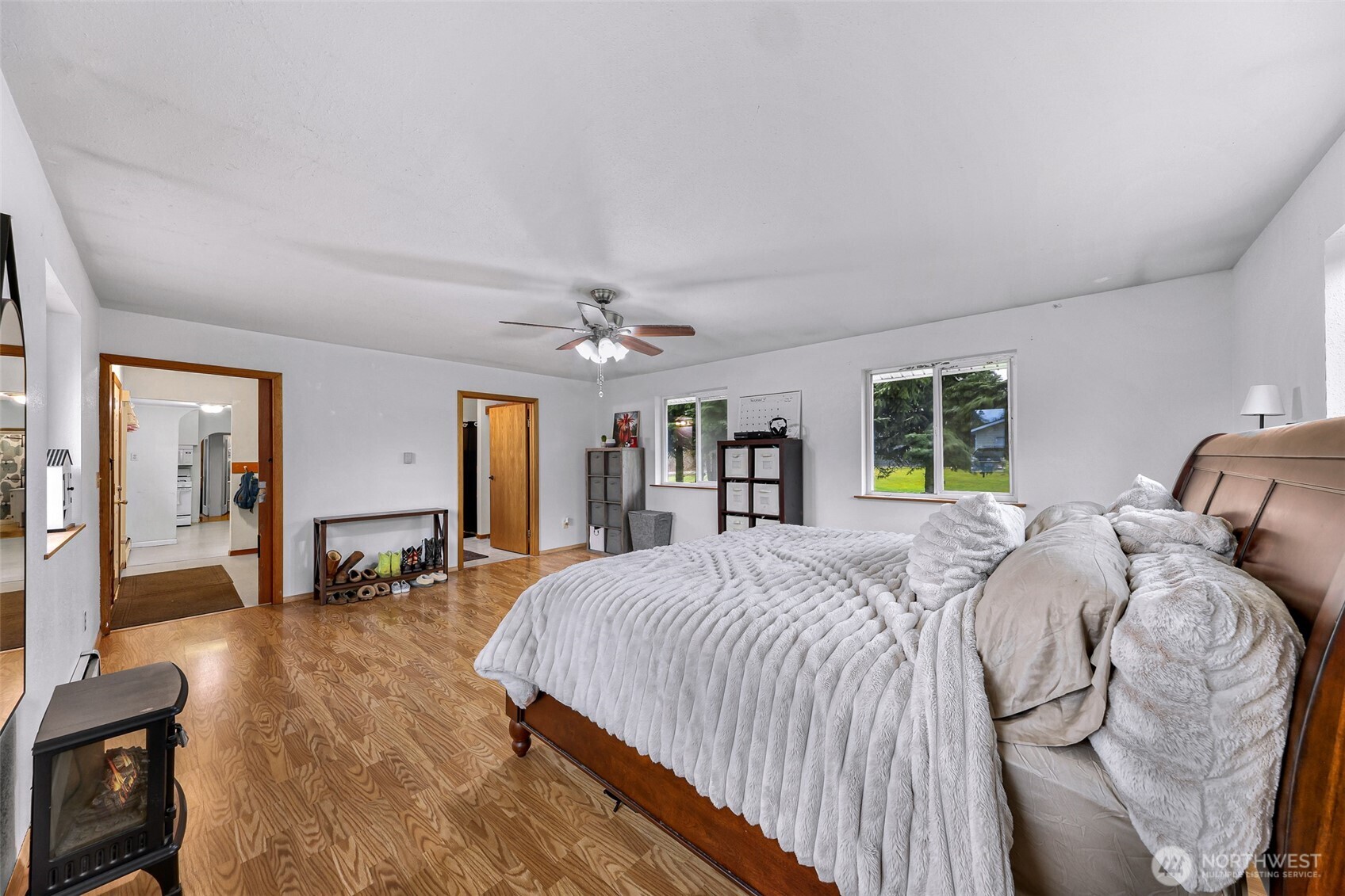 4610 Curtis Road Bellingham, WA 98226 - Photo 17 of 34 a spacious bedroom with a bed a dresser and wooden floor