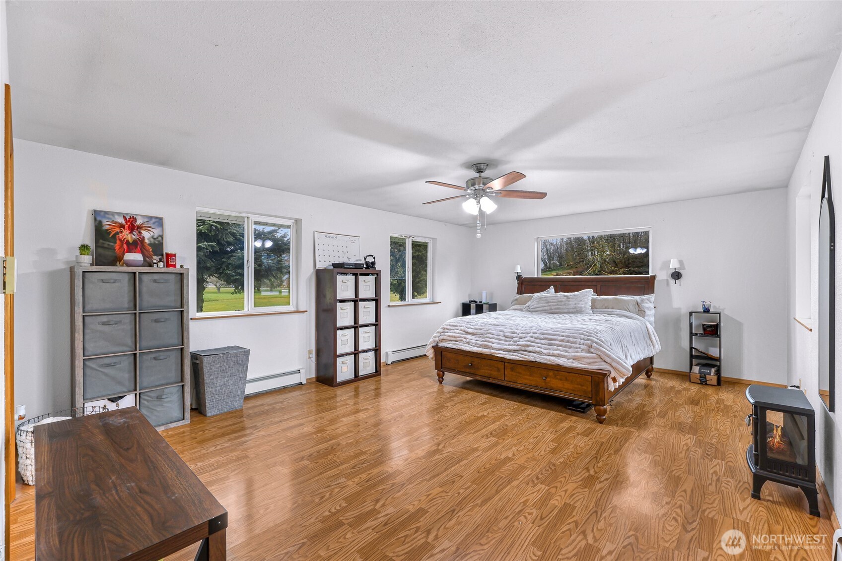 4610 Curtis Road Bellingham, WA 98226 - Photo 18 of 34 a bedroom with a large bed a chandelier and dresser